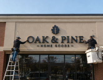 Professional sign company on Long Island installing custom commercial signage on a business storefront.